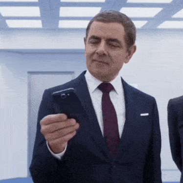 Johnny English inspecting an modern phone